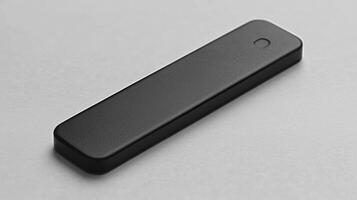 Black rectangular device on grey background. photo
