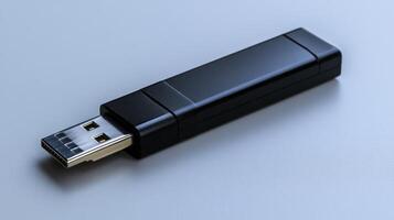 Black USB flash drive on gray surface. photo