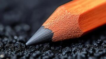 Close-up of sharpened pencil on graphite. photo