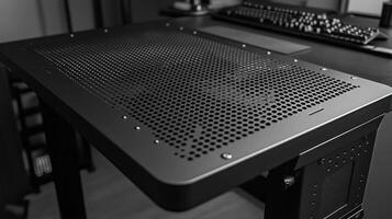 Perforated metal desk panel with fan. photo