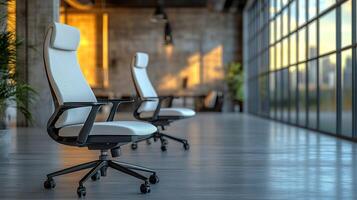 Two modern office chairs near a large window in a loft-style office. photo