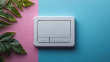 White smart home control panel on pink and blue background. photo