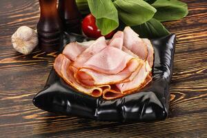 A plate with ham and vegetables on it photo