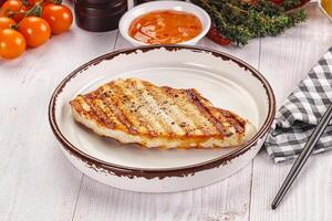 A plate of food with a grilled piece of meat photo