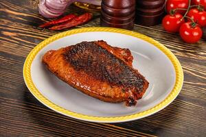 Grilled pork on a plate with tomatoes and spices photo