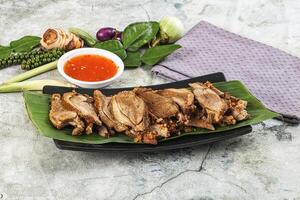 Chicken on a plate with sauce and vegetables photo