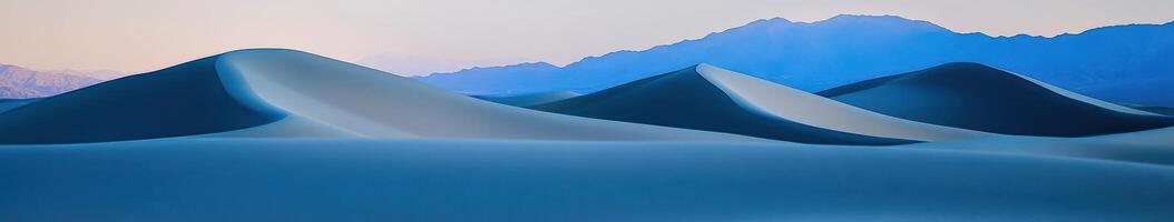 A blue mountain range with a blue sky photo