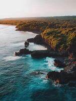 Beautiful aerial view of the ocean and the coastline at sunset photo