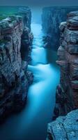 A river flows through a canyon at dusk photo