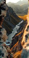 A river runs through a valley in the mountains photo