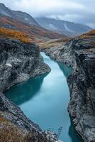 A river runs through a canyon in the mountains photo