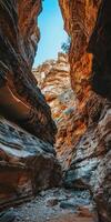 A narrow canyon in the desert with a blue sky photo