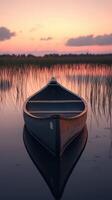 A boat floating in the water at sunset photo