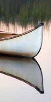 A canoe is reflected in the water photo