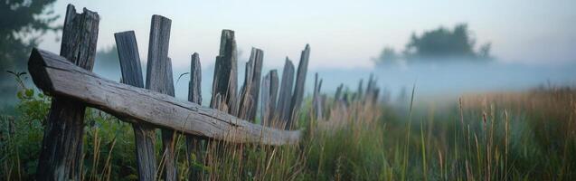 A fence is shown in the misty morning photo