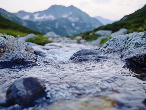 A stream running through a mountain valley photo