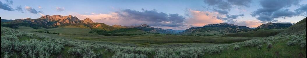 A panoramic view of a mountain range with clouds photo