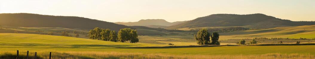 A scenic view of a green valley with mountains in the background photo