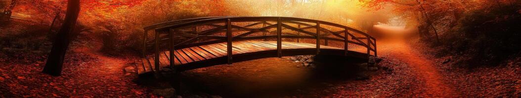 A bridge in the woods with red leaves photo