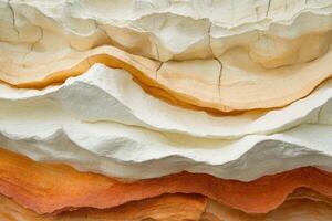 A close up of a pile of white and orange colored rocks photo