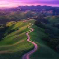 A winding road runs through a green valley photo