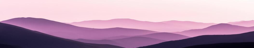 A purple sky with mountains in the background photo