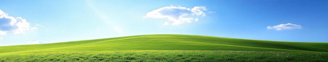 A green hill with blue sky and clouds photo