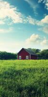 A red barn in a field with a blue sky photo