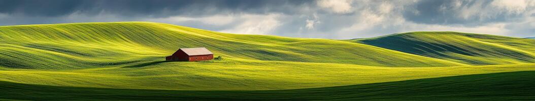 A red house sits on top of a green hill photo