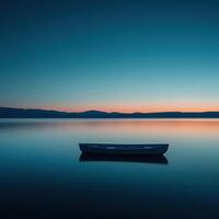 A boat sits on the water at sunset photo