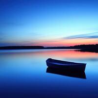 A boat is sitting on the water at sunset photo