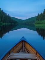 A canoe is floating on a calm lake at dusk photo