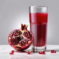 Fresh pomegranate juice in a glass close-up. Ripe pomegranate isolated on a light background. Element of packaging and advertising design photo