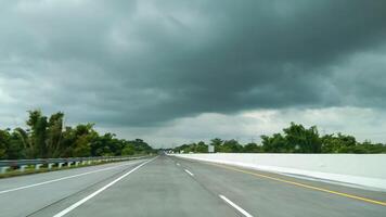 view of the toll road with cloudy clouds photo