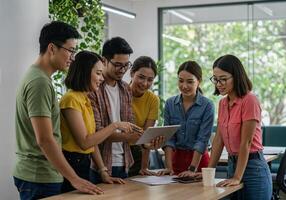 Group of young asian people working together in an office photo