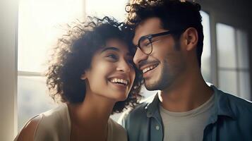 A happy couple is smiling and laughing together in the sunlight photo