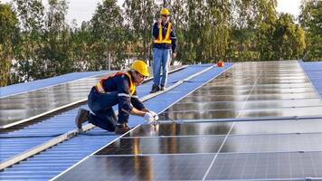 Two workers n safety gear i nstalling solar panels on a rooftop, highlighting renewable energy, sustainability, and the integration of skilled labor in setting up efficient solar power systems. photo