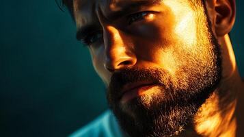 Intense portrait of a man with a beard captured with dramatic lighting that highlights his striking facial features photo