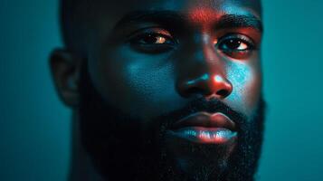 Portrait of a handsome man with beard highlighted by blue and red light captured with a detailed close up photo