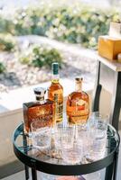 Austin, Texas, USA - April 15, 2024. Bottles of whiskey stand on the table next to the glasses photo