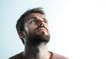 Introspective gaze A man looks upwards with focused eyes illuminated against a light background in a thoughtful moment photo