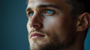 Intense gaze from a man with striking blue eyes creating a captivating and profound sense of thoughtfulness and emotion photo