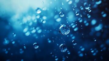 A captivating close-up reveals numerous water droplets suspended against an abstract blue backdrop creating a mesmerizing effect photo