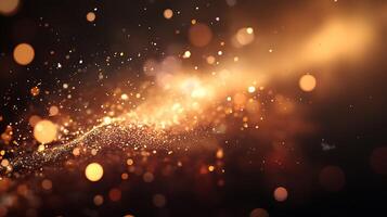 An abstract of illuminated golden particles scattered against a gradient dark background creating a dreamy ethereal effect photo