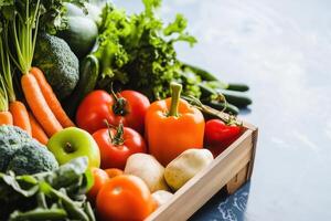 An array of fresh and colorful vegetables and fruits spills from a wooden crate, promoting healthy eating. photo