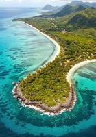 Overhead view of a tropical island featuring inviting turquoise waters, sandy beaches, and rich greenery. photo