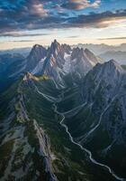 Breathtaking aerial view of the Dolomites mountains and the serene river winding through the valley at sunrise. photo