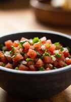 A rustic bowl filled with fresh pico de gallo, a delightful mix of tomato, onion, and cilantro photo