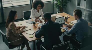 Diverse business team collaborates on financial analysis during a productive meeting in the office. photo