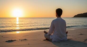 A man meditates on the beach at sunset, embracing peace and serenity in a tranquil coastal setting. photo